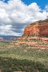 Sedona, Arizona, red rock formations and scenic landscapes under dramatic cloud-filled skies, capturing the natural beauty of the desert wilderness.