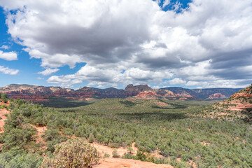Sedona, Arizona, red rock formations and scenic landscapes under dramatic cloud-filled skies, capturing the natural beauty of the desert wilderness.