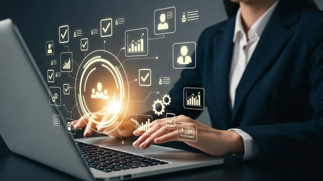 Woman in suit typing on laptop with digital business icons overlayed on the screen interface view - Powered by Adobe