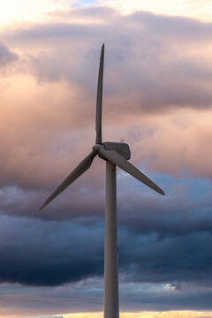 Wind turbine in Aragon Spain framed by dramatic clouds showing the harmony of technology and nature