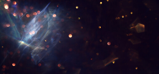 abstract glitter black and gold lights background. de-focused