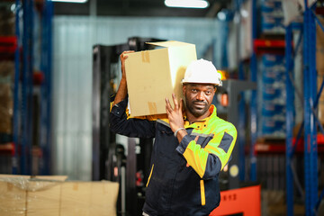 Worker lifts a heavy box and sets it on a high shelf. He appears dedicated and careful while performing his job.