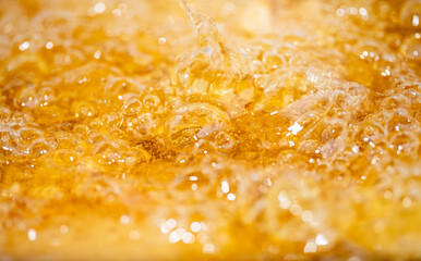 Close up bright orange Oil or beer splash texture and nature waves, Beautiful waves curve and little bubbles smooth for graphic design and background, Oil Bubbles, Soft beer bubbles, Selective focus