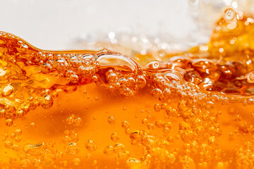 Close up bright orange Oil or beer splash texture and nature waves, Beautiful waves curve and little bubbles smooth for graphic design and background, Oil Bubbles, Soft beer bubbles, Selective focus