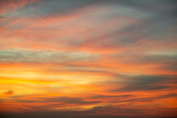 Sky,Beautiful sunset view, luxury soft gradient orange gold clouds and sunlight on the blue dramatic sky perfect for the background, morning, evening,Twilight, climate change,horizontal sunset photo