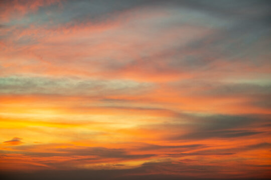 Sky,Beautiful sunset view, luxury soft gradient orange gold clouds and sunlight on the blue dramatic sky perfect for the background, morning, evening,Twilight, climate change,horizontal sunset photo