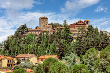The medieval village of Montecatini Alto, located in the province of Pistoia in Italy, is nestled atop a hill and showcases its beautiful medieval architecture surrounded by lush greenery.