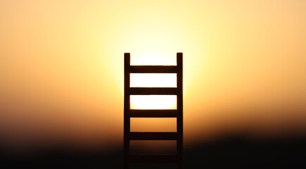 Ladder in nature in front of bright sunlight. Concept of freedom and success