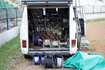 Broadcast Van Filled with Technical Equipment and Cables. Live Event Production, Media Setup, and Field Broadcasting Operations