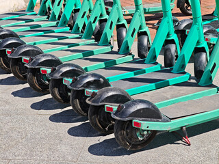 Row of electric scooters for public share. Electric urban transportation. Urban Mobility