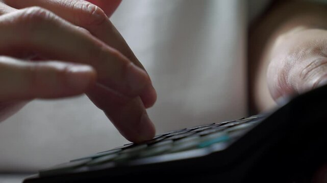 An economist in the office calculates profit on a calculator.
Mathematical calculations and algorithms.
A banker presses the calculator buttons to calculate income.
Using a calculator