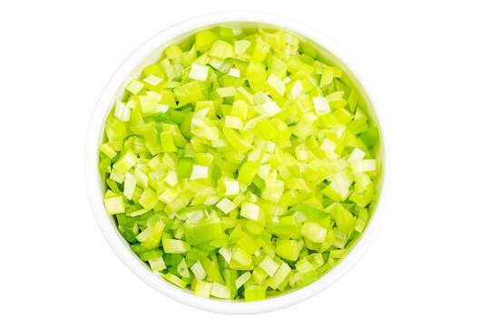 Freshly chopped green celery in white bowl isolated on white background