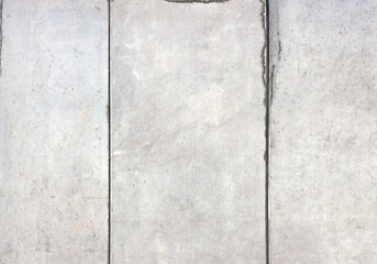 Fair faced concrete with a smooth, fine pored surface. The concrete surface has a subtle, even grain with slight formwork imprints and gentle color gradients in shades of grey and concrete.