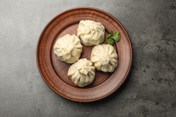 Delicious khinkali served on grey table, top view