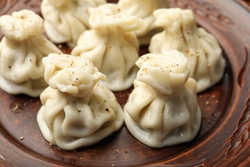 Delicious khinkali with spices on plate, closeup