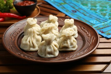 Delicious khinkali served on wooden table, closeup