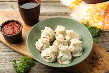 Delicious khinkali served on wooden table, above view