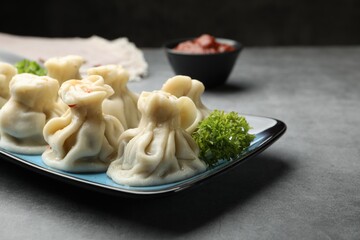 Delicious khinkali served on grey table, closeup
