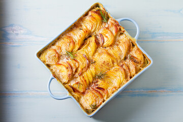 Tender creamy potato gratin. Scalloped potatoes or potato bake. High angle view