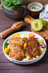 Fish cakes with vegetables and mashed potatoes. Fish patties or burgers