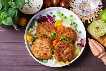 Fish cakes with vegetables and mashed potatoes. Fish patties or burgers. View from above, top studio shot