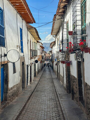 "Narrow and colorful streets wind through the city of Cusco, Peru, with balconies full of vibrant flowers. A charming blend of colonial architecture and Andean culture in one of South America's most h