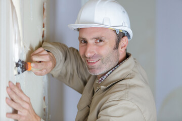 worker making repair in room
