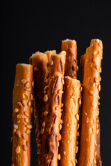 salted breadsticks with sesame seeds, close arrangement, baked snack