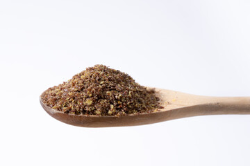 Cold milled flaxseed, rich in Omega 3, magnesium, fiber, on wooden spoon
