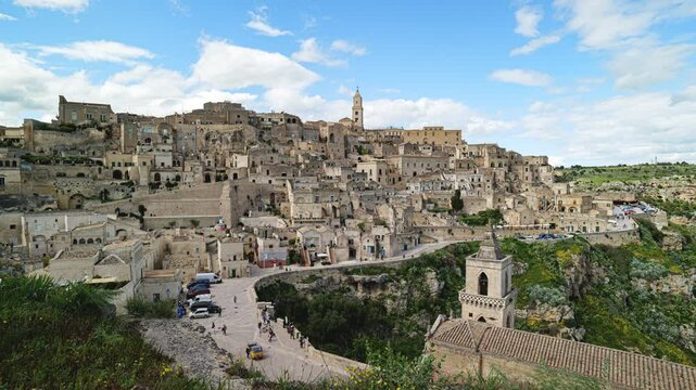 Sassi di Matera (MT), Italy. Panoramic view of the Sassi of Matera. Above, the bell tower of the Basilica of Matera Maria Santissima della Bruna. Below, the church of San Pietro Caveoso.