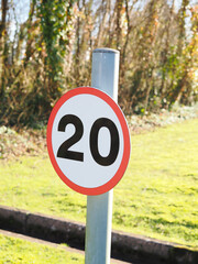 close up of a UK maximum road speed limit sign showing 20 mph as the top speed
