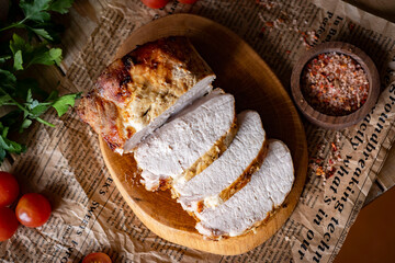 Baked pork sliced on a board. View from above. Slices of pork for lunch. Close-up