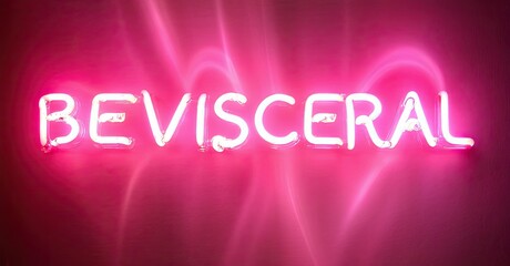 Obraz premium Bright pink neon sign spells BEVISCERAL against dark background. Intense glow radiates outward, creating dramatic effect.