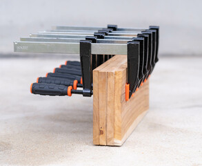 Woodworking F Clamps Securing Wooden Boards on Workshop Floor