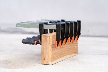 Woodworking F Clamps Securing Wooden Boards on Workshop Floor