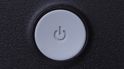 Close-up of a power button, a symbol for starting or stopping technology, on a clean white or black background