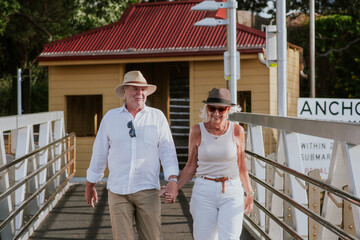 happy senior couple walking to the ferry in Sydney