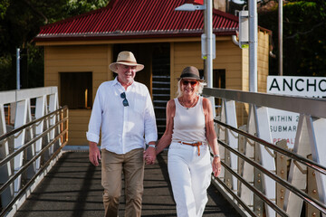 happy senior couple walking to the ferry in Sydney