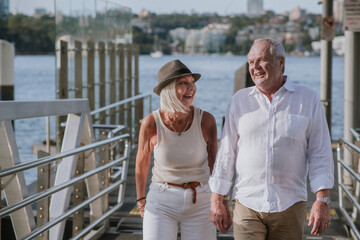 happy couple walking on jetty by the water