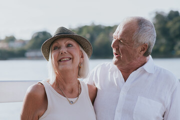 happy couple walking on jetty by the water