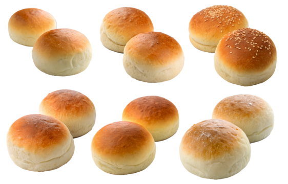 Various soft buns are laid out on a transparent surface with different textures and fillings, such as sesame seeds and flour. The golden brown crust indicates freshness.