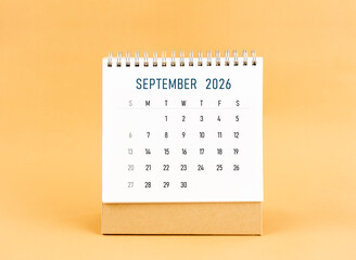 September 2026 desk calendar on yellow background, Front view.
