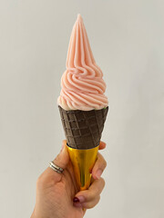 Peach yogurt mixed matcha soft serve ice-cream in chocolate cone