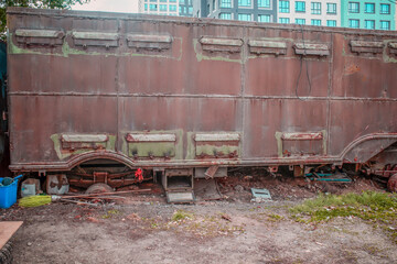 An abandoned rusty trailer on a summer day