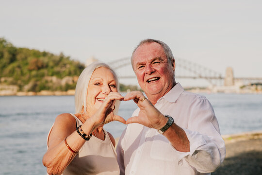 senior couple making heart hands together