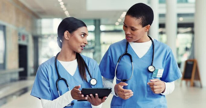 Walking, team and nurses talk with tablet in hospital for healthcare, diagnosis update and results. Women, technology and discussion with medical surgeon for planning, report and clinic schedule