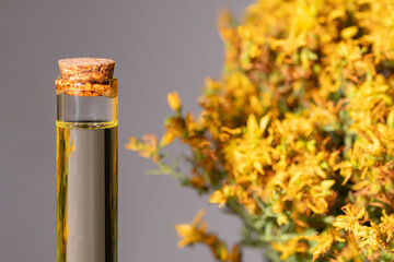 Hypericum - St. St. John's wort herbs, oil or infusion bottle, mortar on a wooden board.