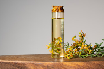 Hypericum - St. St. John's wort herbs, oil or infusion bottle, mortar on a wooden board.