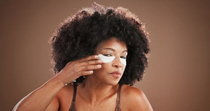 Studio, woman face and wellness with eye mask for skincare, facial treatment or collagen with smile. Afro, African person and portrait with gel patches for cosmetics, beauty and space in background