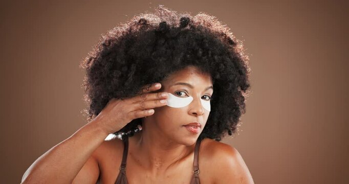 Studio, woman face or skincare with eye mask for wellness, treatment or collagen with smile. Touch, African person or portrait with gel patches for beauty, cosmetics or antiaging in mockup background